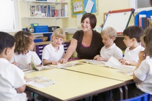 students-in-class-with-teacher-reading